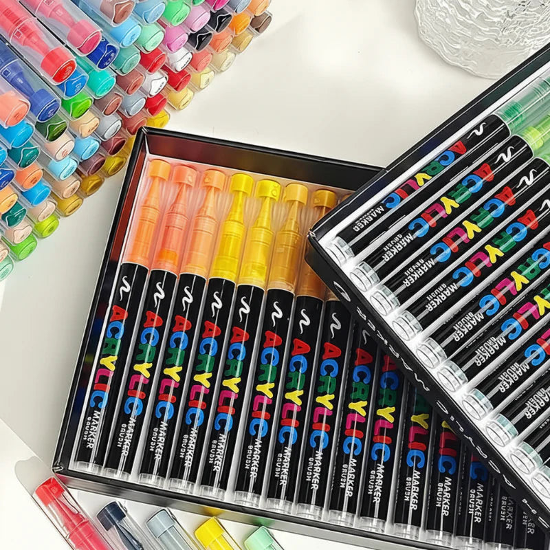 Open trays of acrylic brush markers with assorted color-coded caps