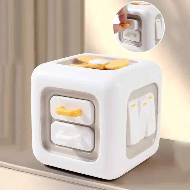 Sensory activity cube with two drawers, press switches, and a yellow spinner on top