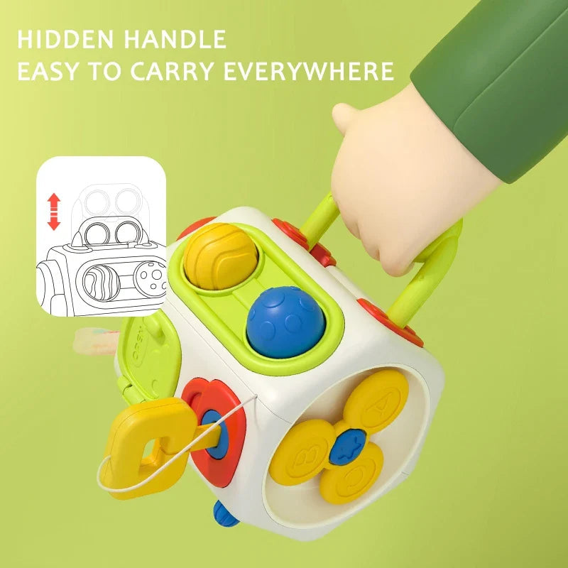 Hand carrying the multicolor activity cube by its retractable green handle