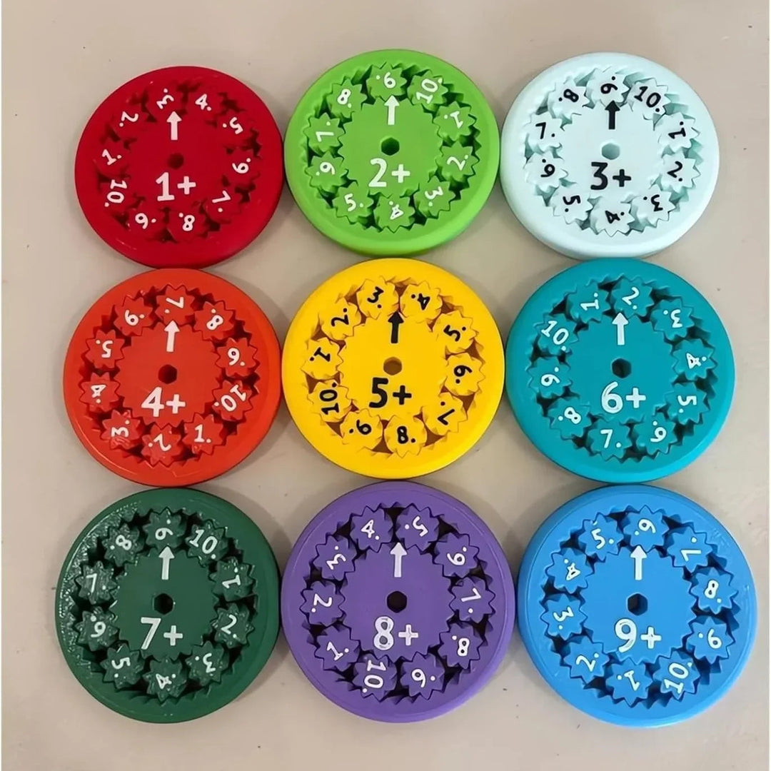 Nine addition spinners arranged in three rows on a tabletop.
