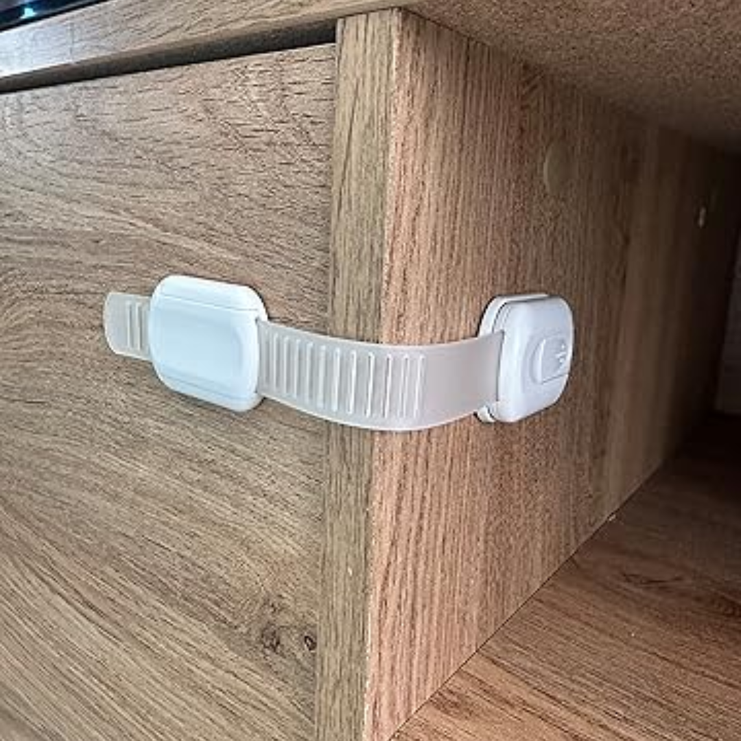White adhesive strap latch fitted around the corner of a wood-grain drawer