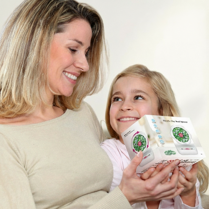 Adult and child holding the boxed electric beading machine.