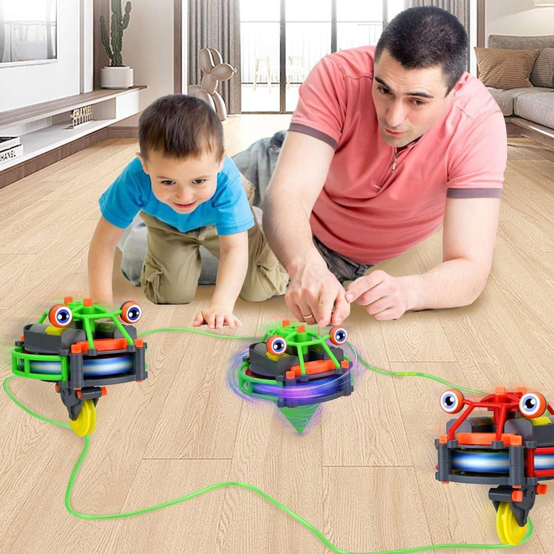 An adult and child watching green and red balancing robots beside a cord on the floor.