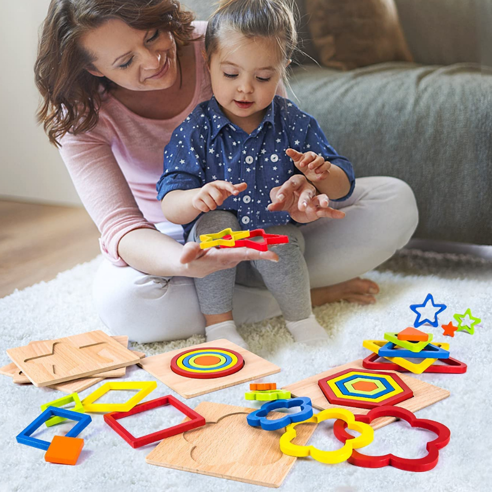 Adult and child exploring colorful wooden shape puzzles on the floor