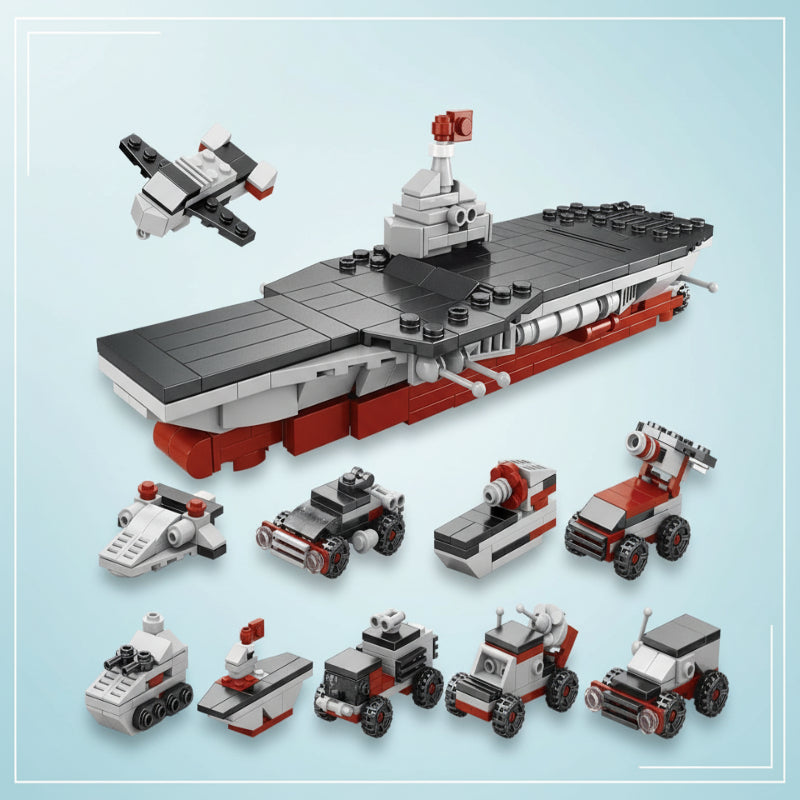 Gray and red aircraft carrier block model with smaller aircraft and vehicles
