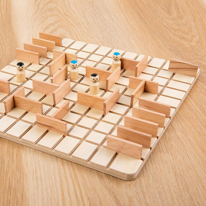 Angled view of the wooden board with four pawns and a layout of barriers
