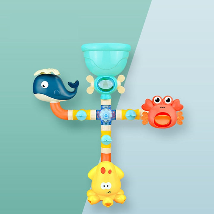 Colorful bath fountain with a turquoise funnel, whale, crab, and yellow lower sprayer on a two-tone background