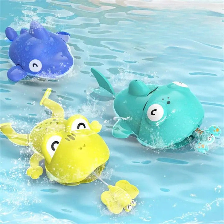 Green frog, turquoise animal, and blue sea-animal bath toys splashing in water