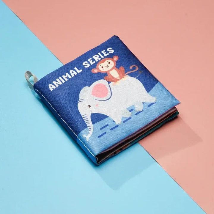 Blue animal-themed cloth book with an elephant and monkey on the cover