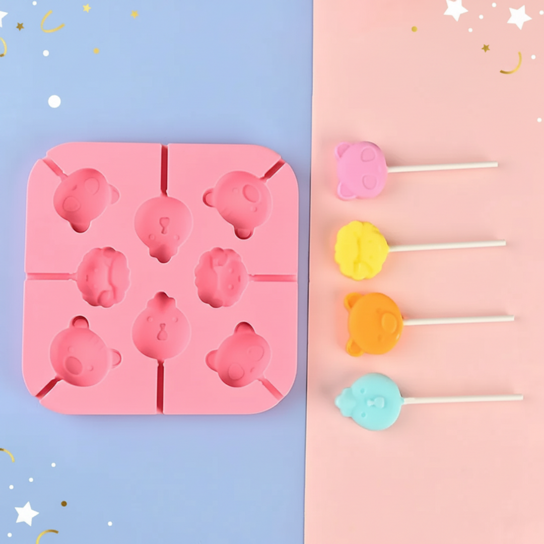 Pink animal-face lollipop mold beside four pastel sample lollipops