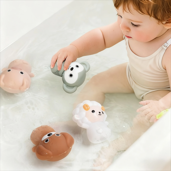Child playing with soft animal figures in water