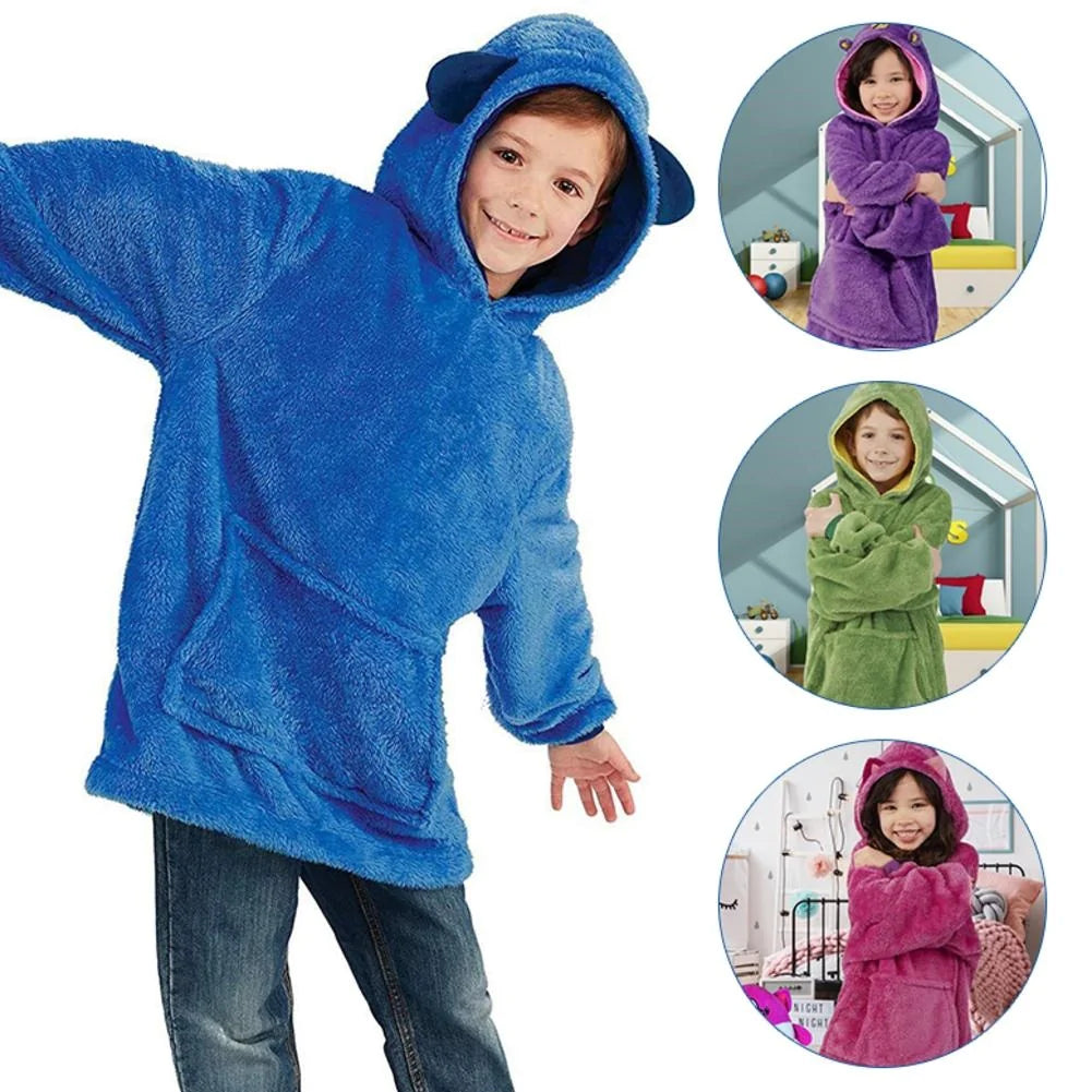 Child wearing a blue creature hoodie, with purple unicorn, green dino, and pink cat styles shown.