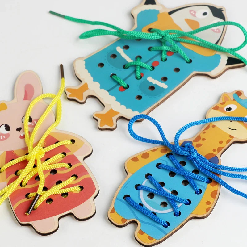 Rabbit, giraffe, and penguin lacing boards with colorful cords tied into bows