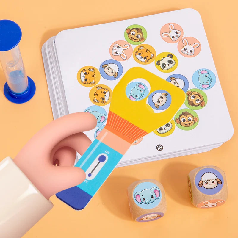 Close-up of a flashlight-shaped paddle over animal pictures, with two animal dice beside the card