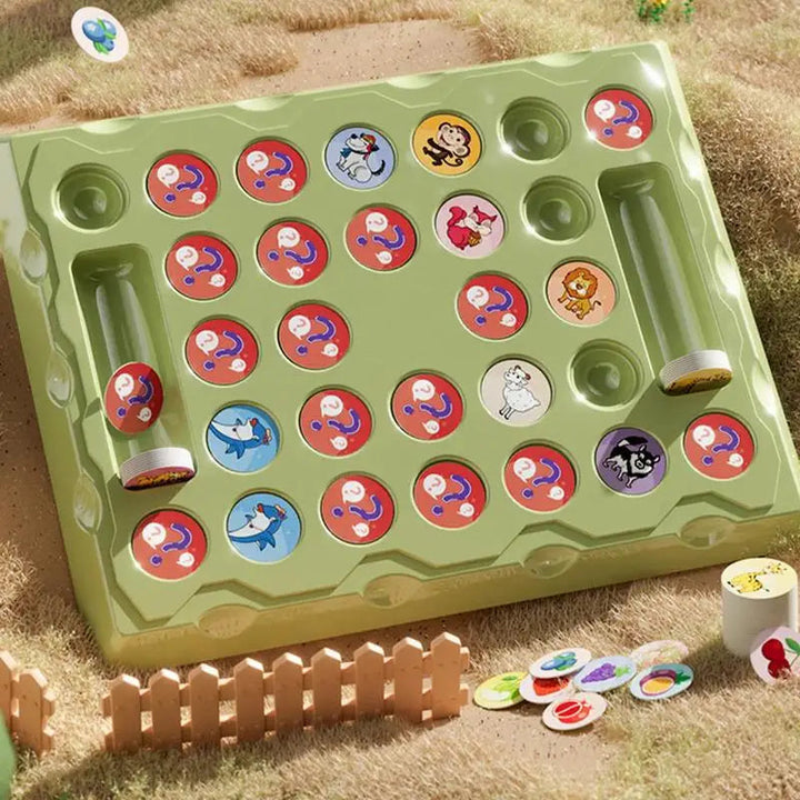 Green animal memory game board with colorful round tokens on a grass-textured surface.