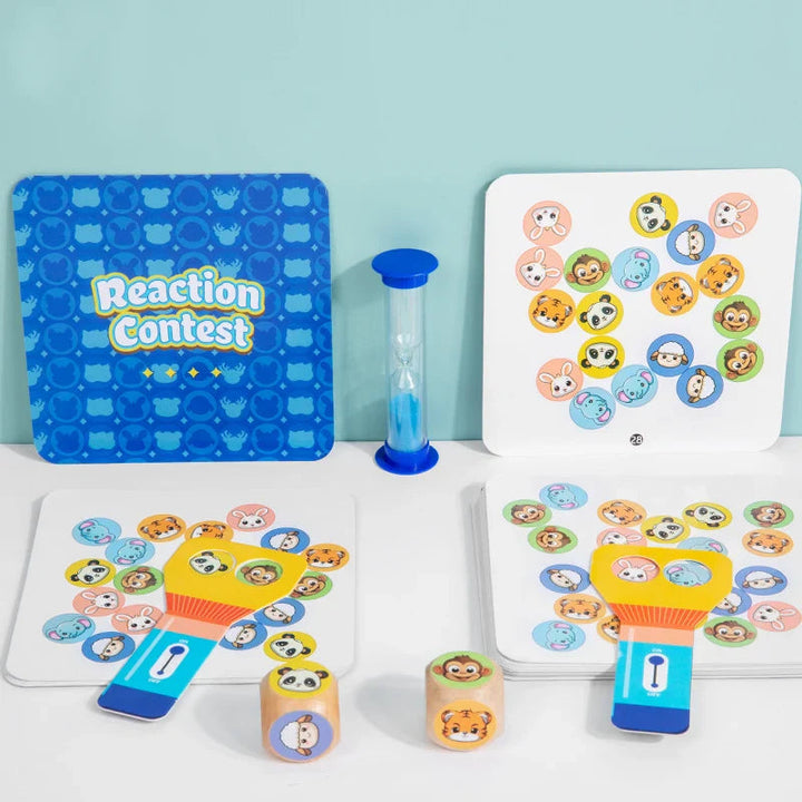 Animal-picture cards arranged with two matching paddles, animal dice, and a blue hourglass