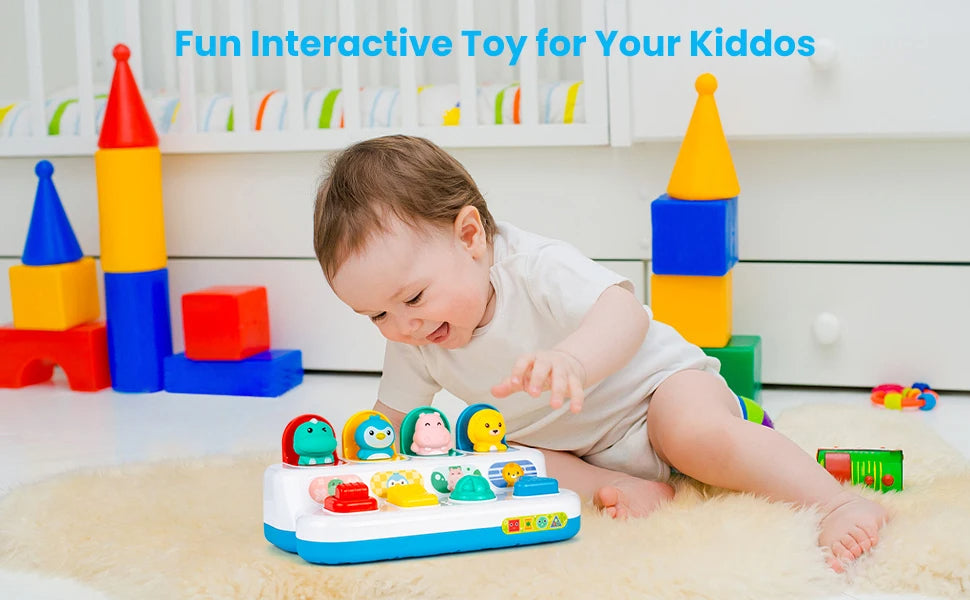 Baby reaching toward the animal pop-up toy on a rug