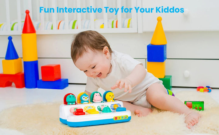 Baby reaching toward the animal pop-up toy on a rug