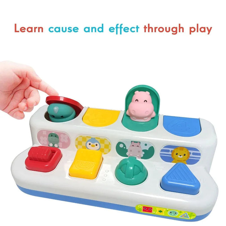 Hand closing a pop-up lid beside an open hippo figure on the animal activity toy