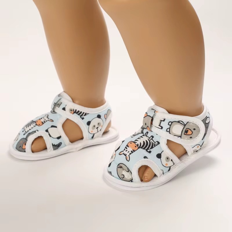 Animal-print baby sandals on display feet, showing open toe and side cutouts