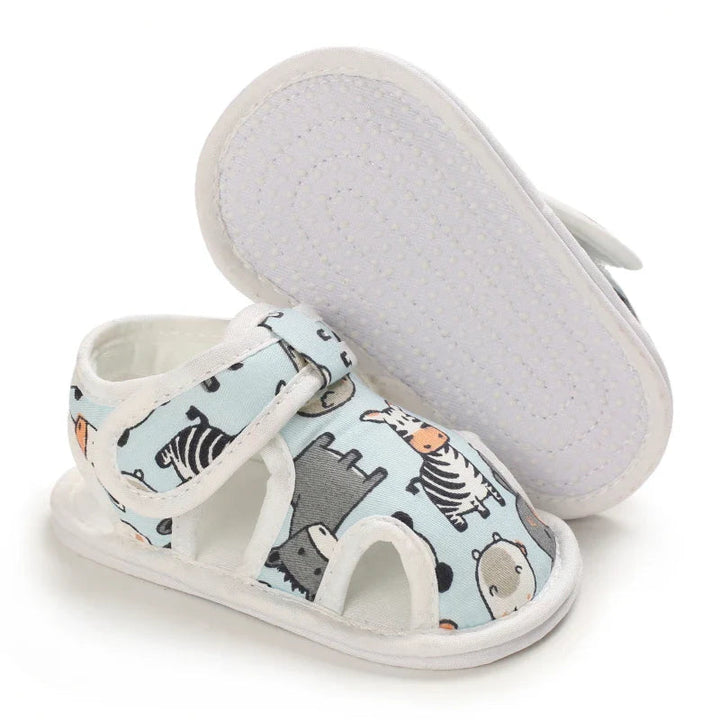 Light blue animal-print sandal beside an upturned sandal showing the white textured sole