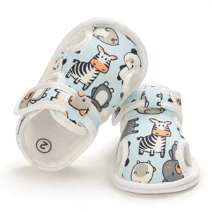 Top view of light blue animal-print sandals with ankle straps and white insoles