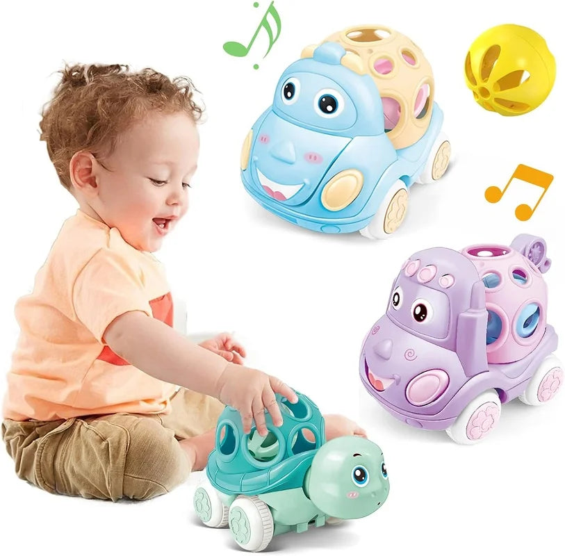 Child playing with a turtle toy car beside blue and purple hippo cars and a yellow rattle ball