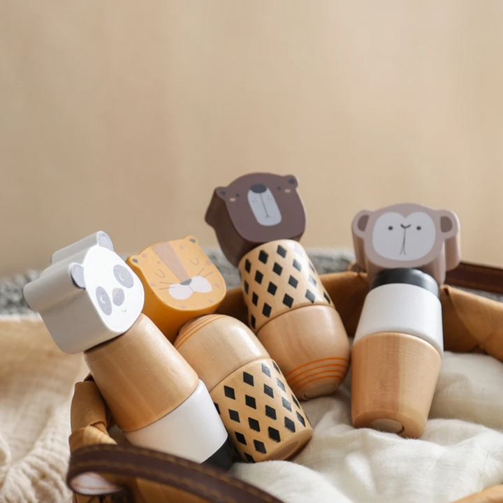 Panda, tiger, bear, and monkey wooden stacking toys nestled in a basket