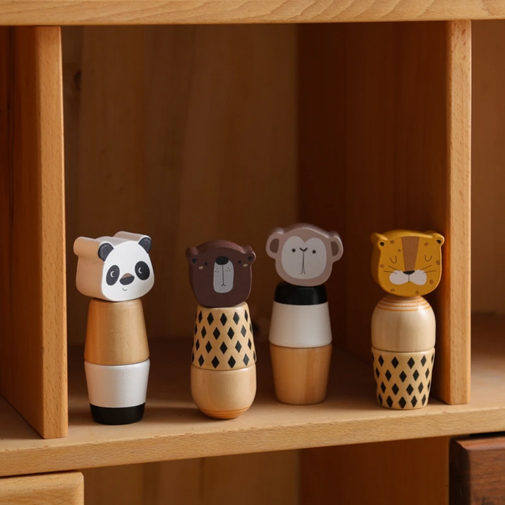 Panda, bear, monkey, and tiger wooden stacking toys standing on a wooden shelf