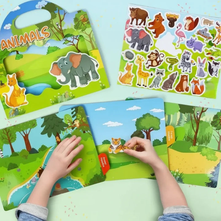 Hands arranging animal stickers on an open fold-out landscape beside the book and sticker sheet.