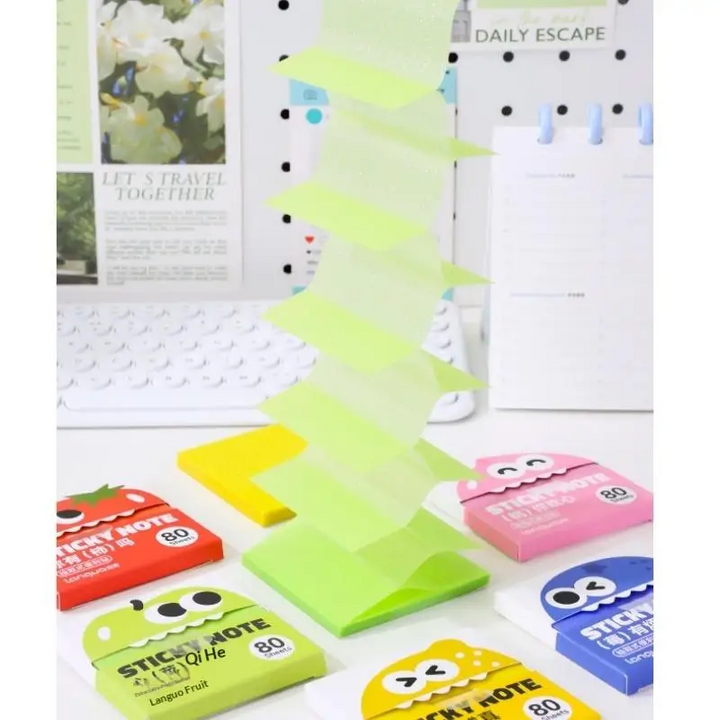 Apple green sticky notes pulled upward from a pack on a desk