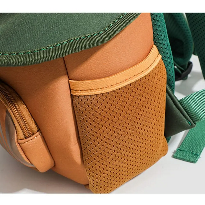 Close-up of the brown mesh side pocket on the Apple Tree backpack.