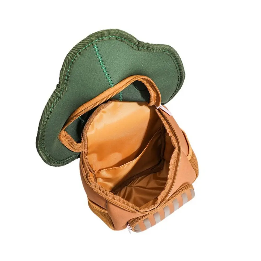 Apple Tree backpack opened to show the lined main compartment beneath its lifted green top.