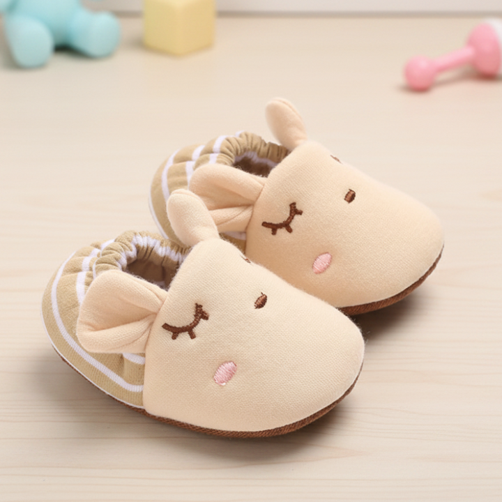 Apricot baby shoes with animal ears and cream-striped ankle cuffs.