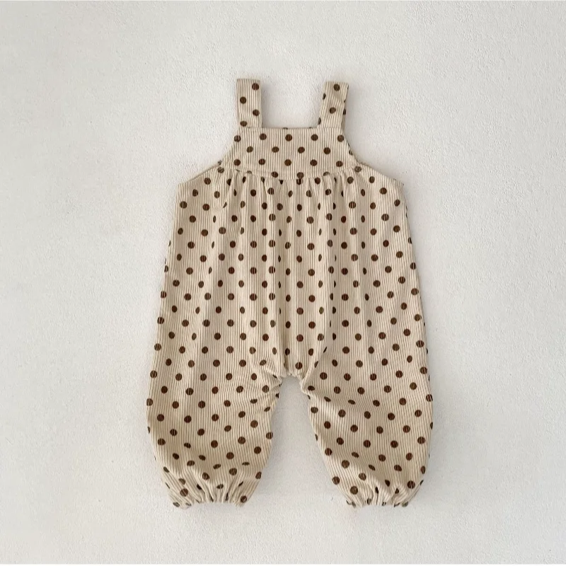 Full-length apricot baby jumpsuit with brown polka dots and gathered legs.