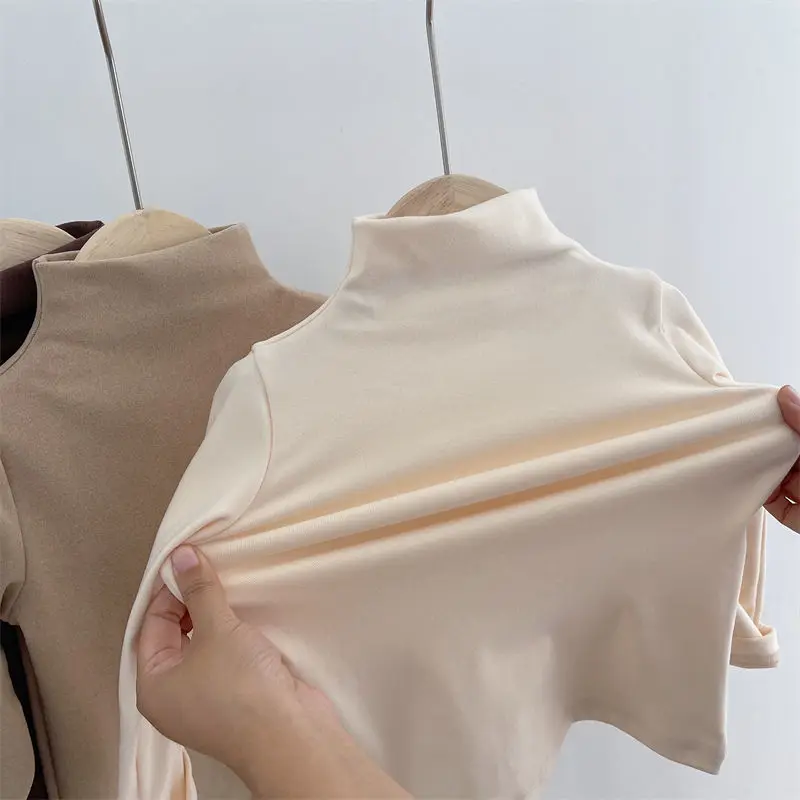 Apricot baby sweater fabric stretched across the front, with a khaki sweater behind it.