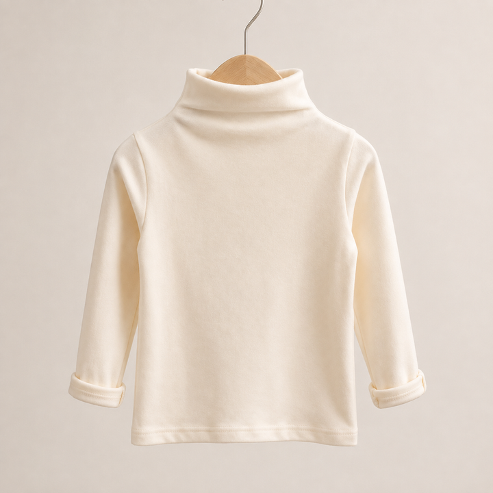 Apricot long-sleeve baby sweater on a wooden hanger with the cuffs turned up.
