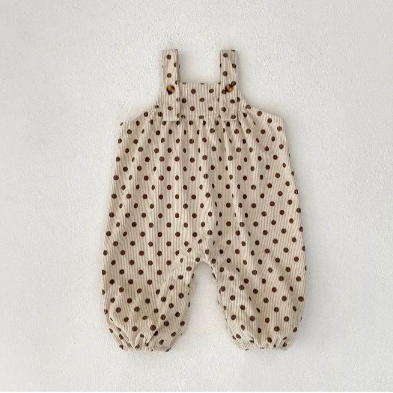Apricot polka-dot baby jumpsuit with wide straps and elastic leg openings, laid flat.