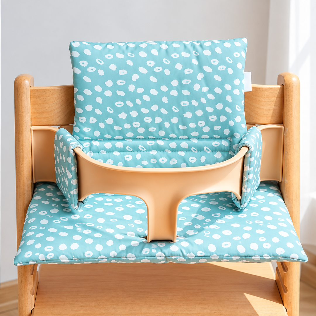 Aqua high chair cushion with white spots, shown on a wooden chair