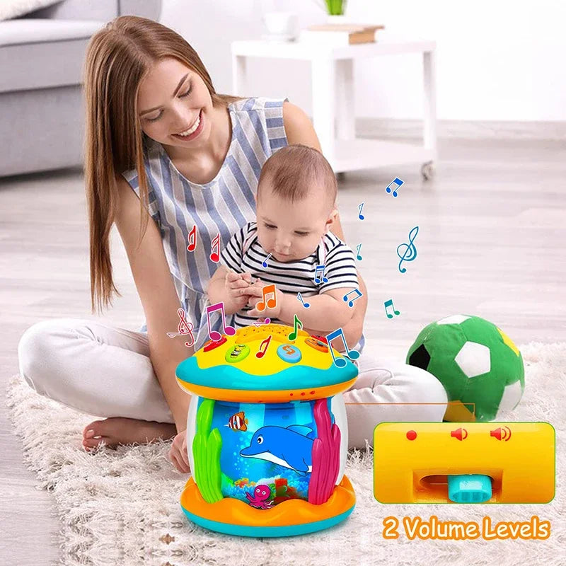 Adult and baby exploring an aquarium musical toy, with a two-level volume switch shown