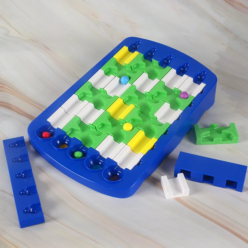 Assembled ball maze on a tabletop with loose track pieces beside the blue board