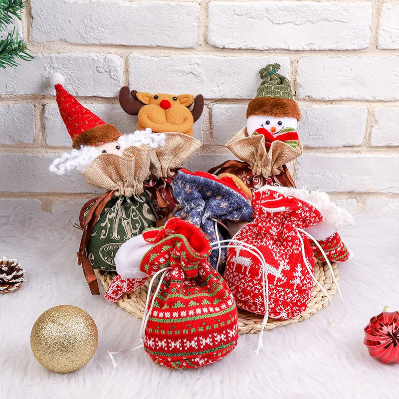 Assorted Christmas character gift bags in red, green, and blue, displayed with holiday ornaments.