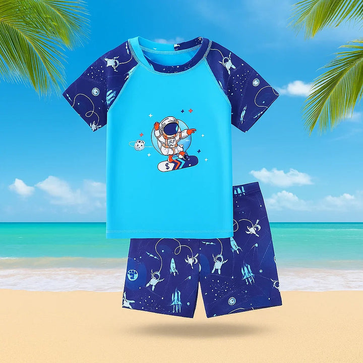 Astronaut swim shirt and space-print shorts against a tropical beach background