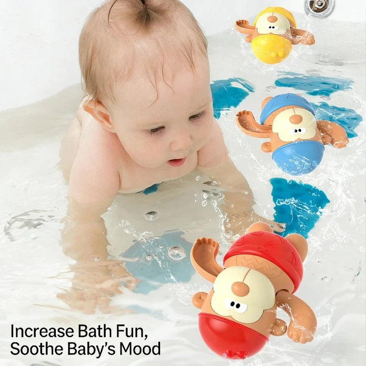 Baby in a bathtub with red, blue and yellow monkey toys floating nearby