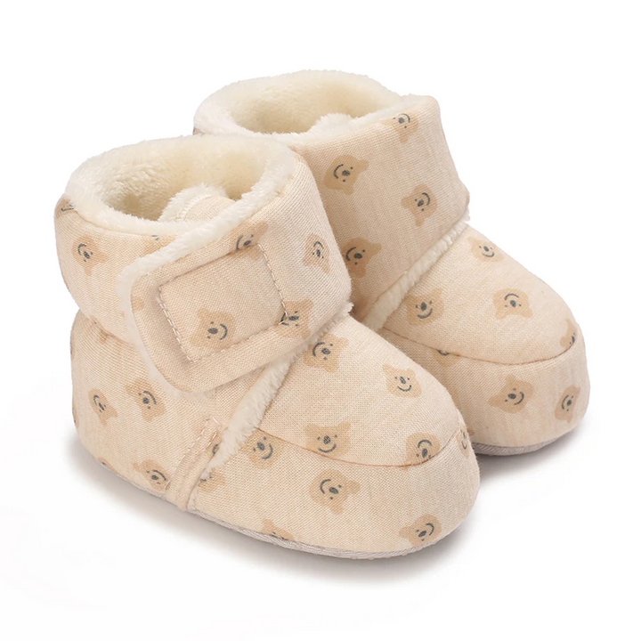 Cream baby boots with an allover small bear print and plush lining
