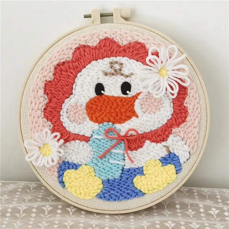 Baby duck punch needle hoop with a red bonnet, white daisies, and yellow feet