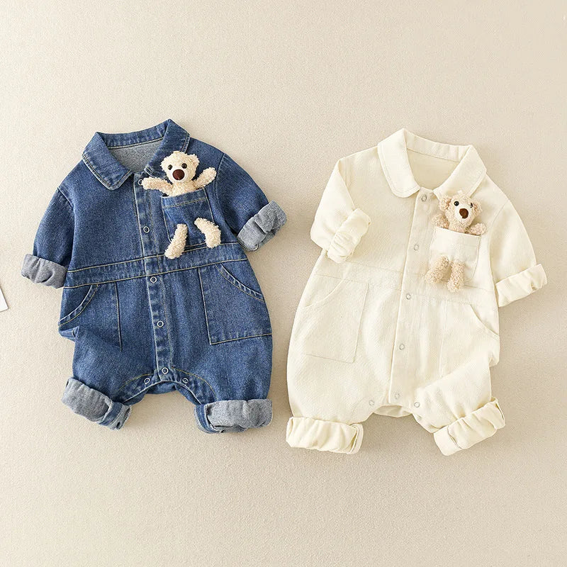 Blue and white baby jumpsuits with collars, rolled cuffs, and bear details at the chest.
