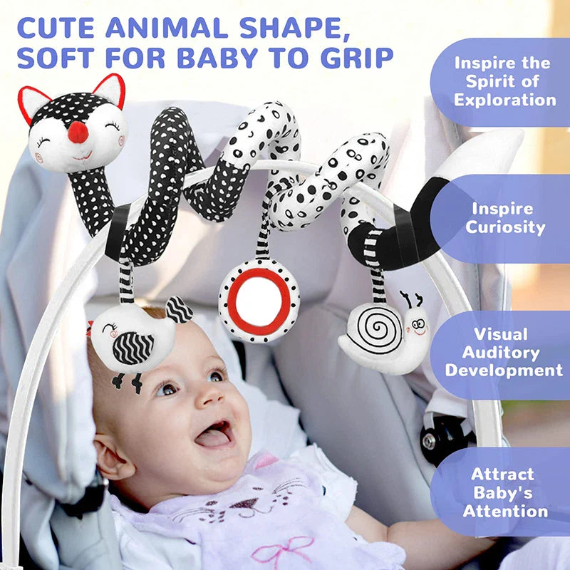 Baby looking up at a black-and-white fox spiral activity toy on a seat handle.