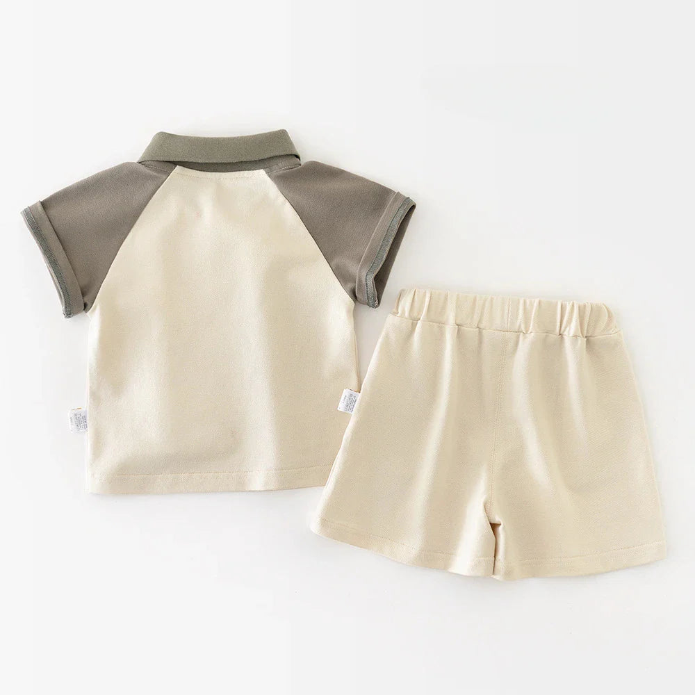 Back view of the ivory and gray baby polo beside matching elastic-waist shorts
