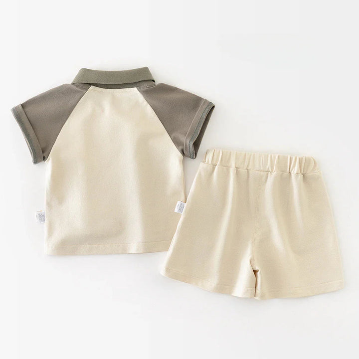 Back view of the ivory and gray baby polo beside matching elastic-waist shorts
